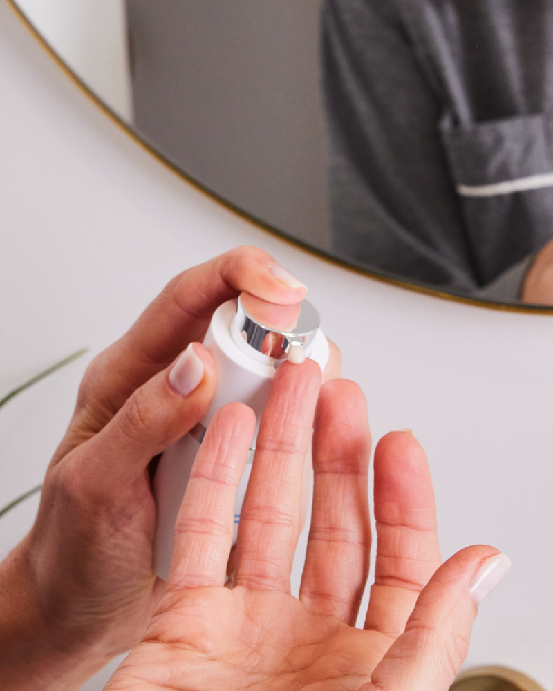 Regenerative ECM Eye Complex cream being dispensed onto finger in gallery position 1 for precise under-eye care