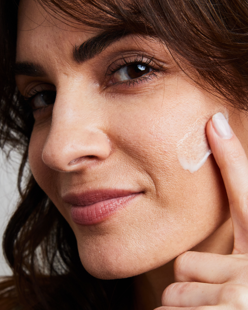 Woman applying NMF Hydrator Barrier Repair developed by Dr. Stefani Kappel for healthy skin from within and hydration boost