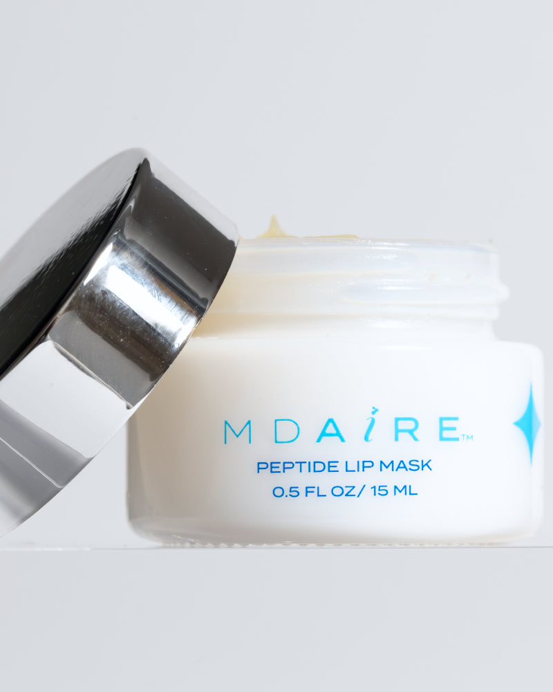 MDAiRE Peptide Lip Mask open jar with reflective silver lid shown close-up in gallery position 1