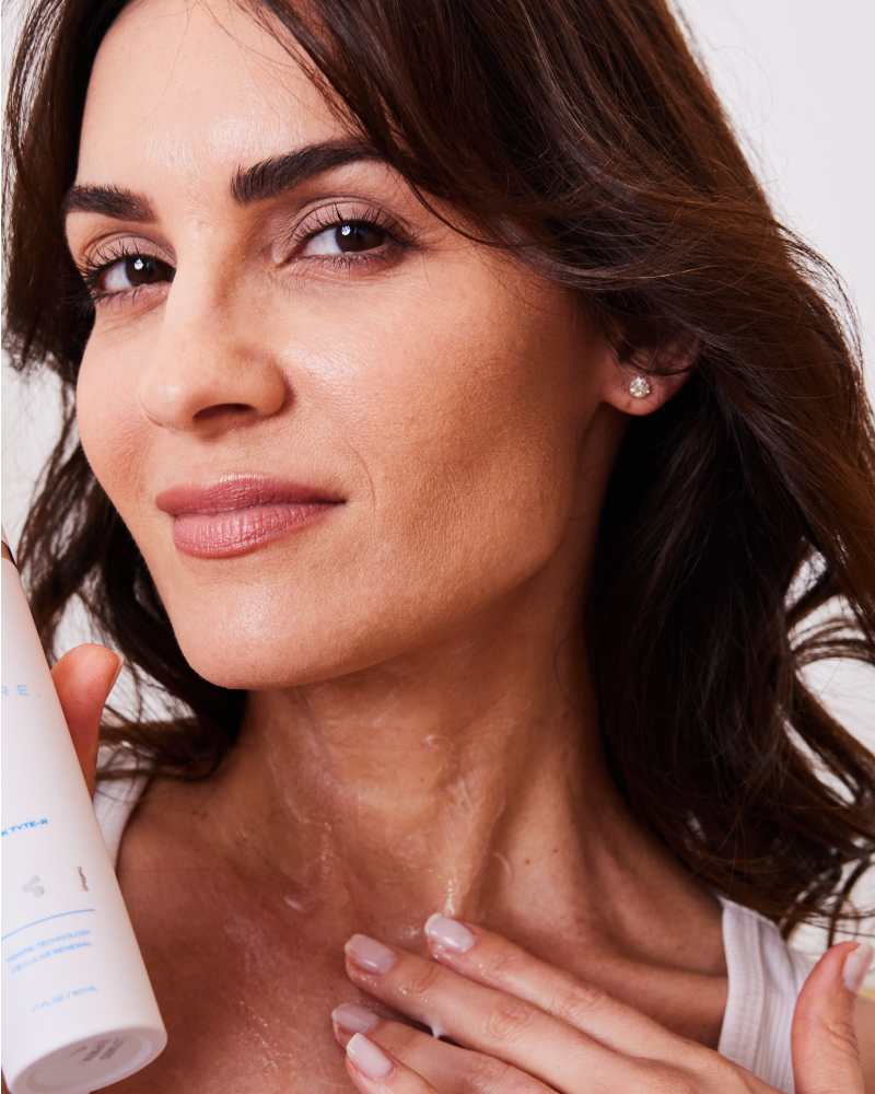 Woman applying Neck Tyte-R moisturizer to neck showing hydration benefits in gallery position 1