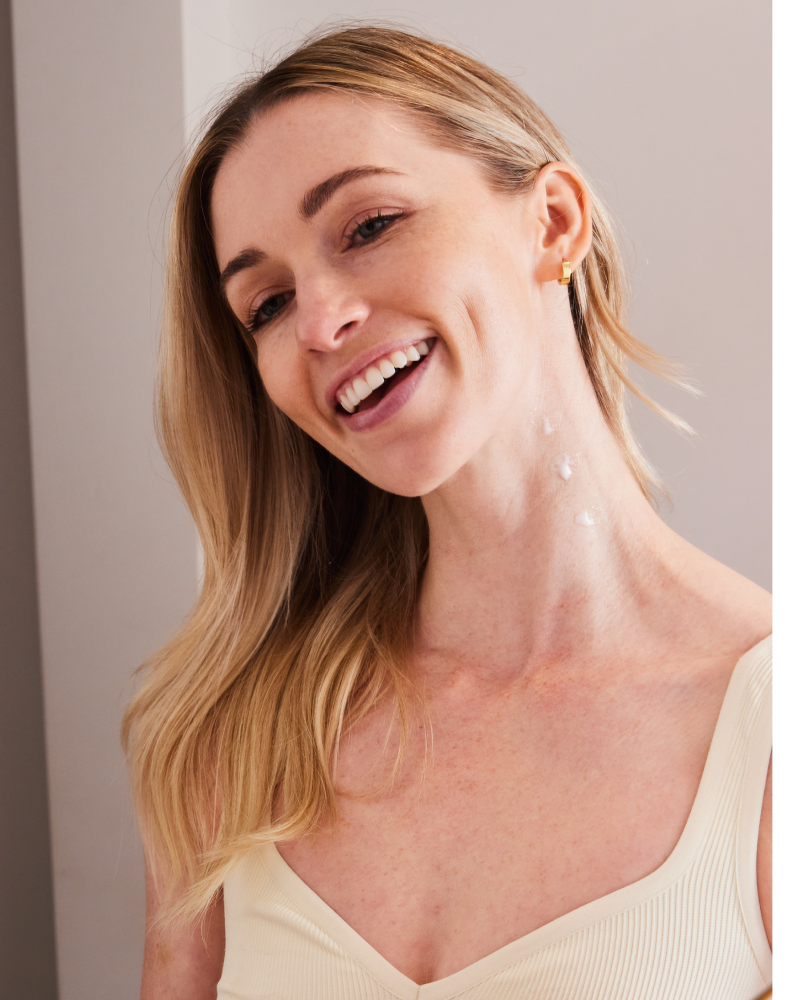 Smiling woman with moisturizer applied to neck demonstrating Neck Tyte-R benefits in gallery position 1