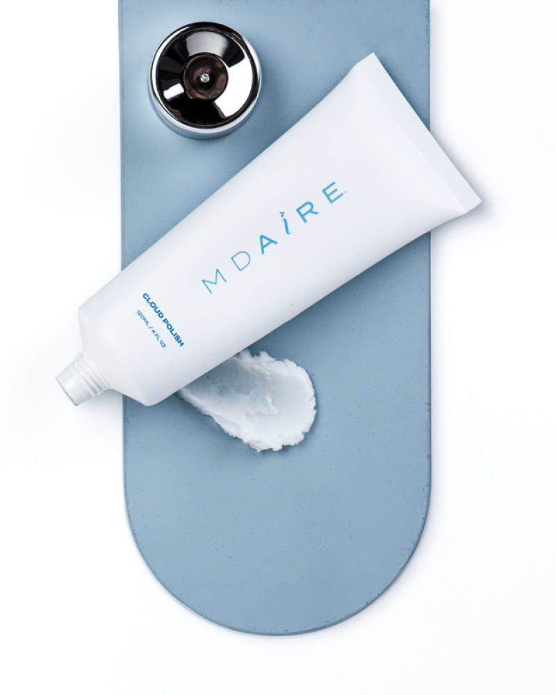 Cloud Polish exfoliant tube with opened cap and swatch on blue surface shown in gallery position 1