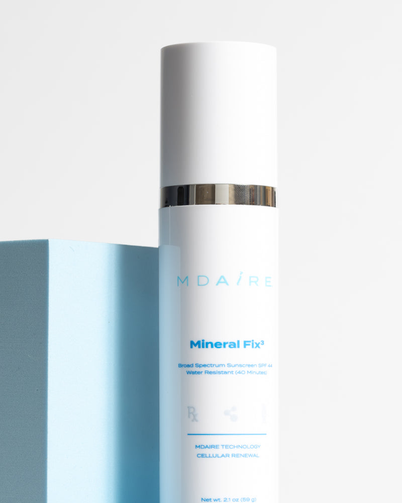 Total Protection SPF Duo featuring Mineral Fix³ white bottle with silver band against blue block gallery 1