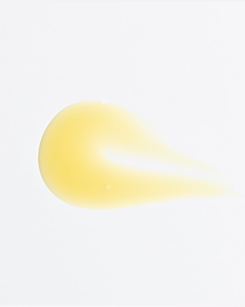 Close-up of Vitamin C-FK Brightening Complex serum drop in gallery position 1 showing smooth texture and pale yellow hue